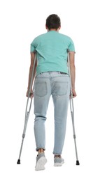 Man with crutches on white background, back view