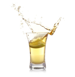 Photo of Splashing Mexican Tequila in shot glass with lime slice isolated on white