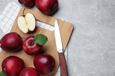 Photo of Fresh ripe red apples and knife on light grey table, flat lay. Space for text