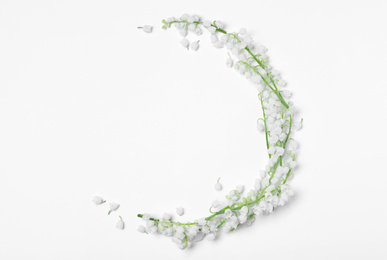 Photo of Beautiful lily of the valley flowers on white background, flat lay. Space for text