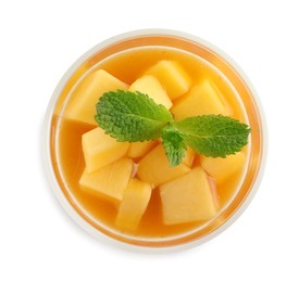 Photo of Delicious mango jelly with fresh fruit pieces and mint isolated on white, top view