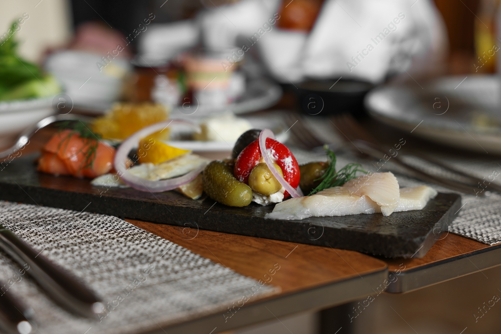 Photo of Tasty appetizers served on table in cafe, closeup