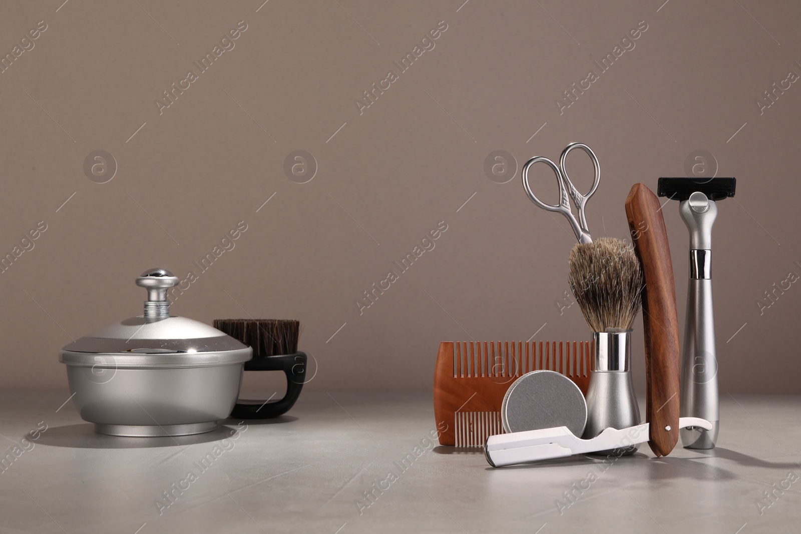 Photo of Moustache and beard styling tools on grey table