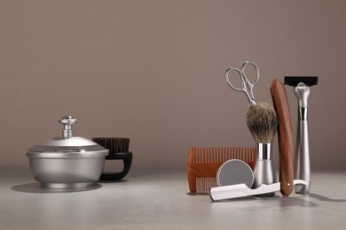 Photo of Moustache and beard styling tools on grey table