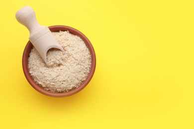 Photo of Beer yeast flakes on yellow background, top view. Space for text