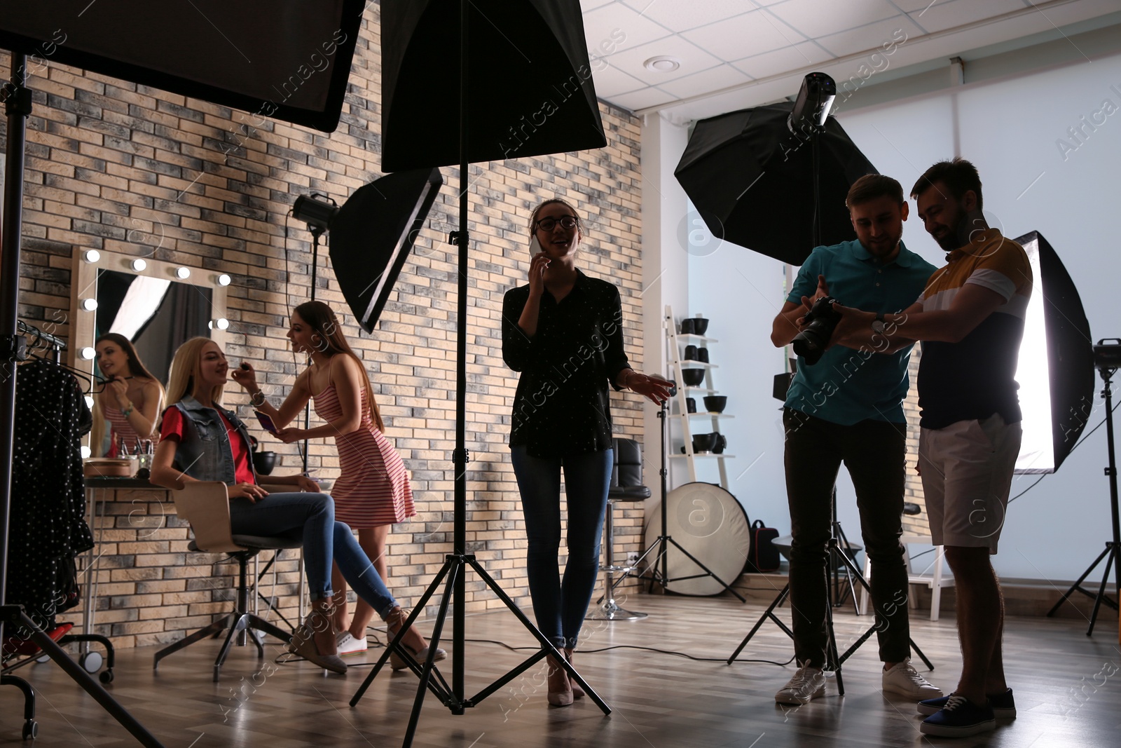 Photo of Professional team working with model in photo studio