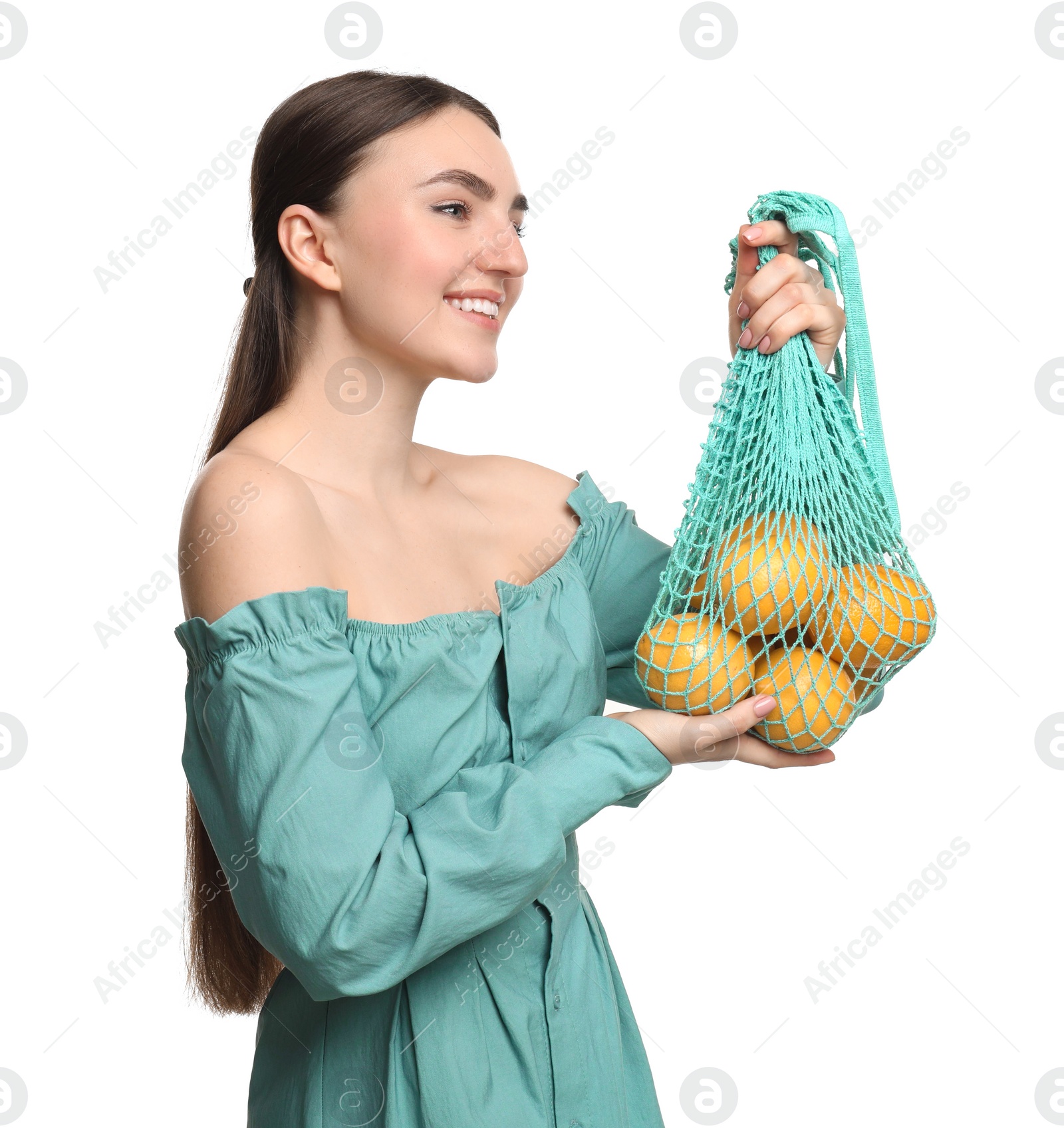 Photo of Woman with string bag of fresh lemons on white background