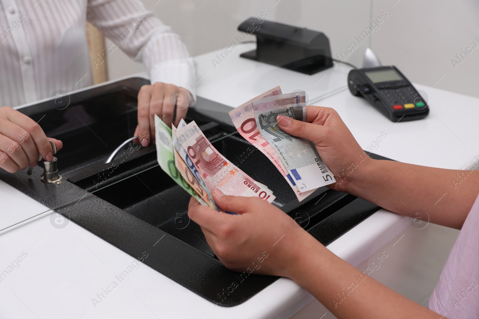 Photo of Woman with money at cash department window, closeup. Currency exchange