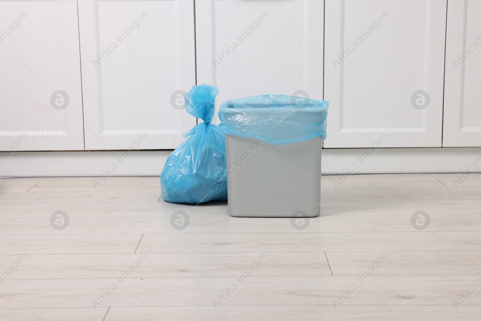 Photo of Plastic garbage bag and trash can indoors