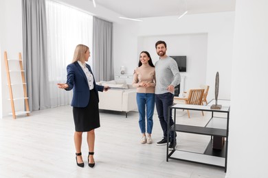 Photo of Real estate agent showing new apartment to couple