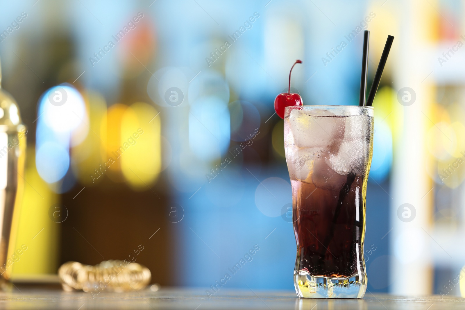 Photo of Fresh alcoholic cocktail with cherry on bar counter, space for text