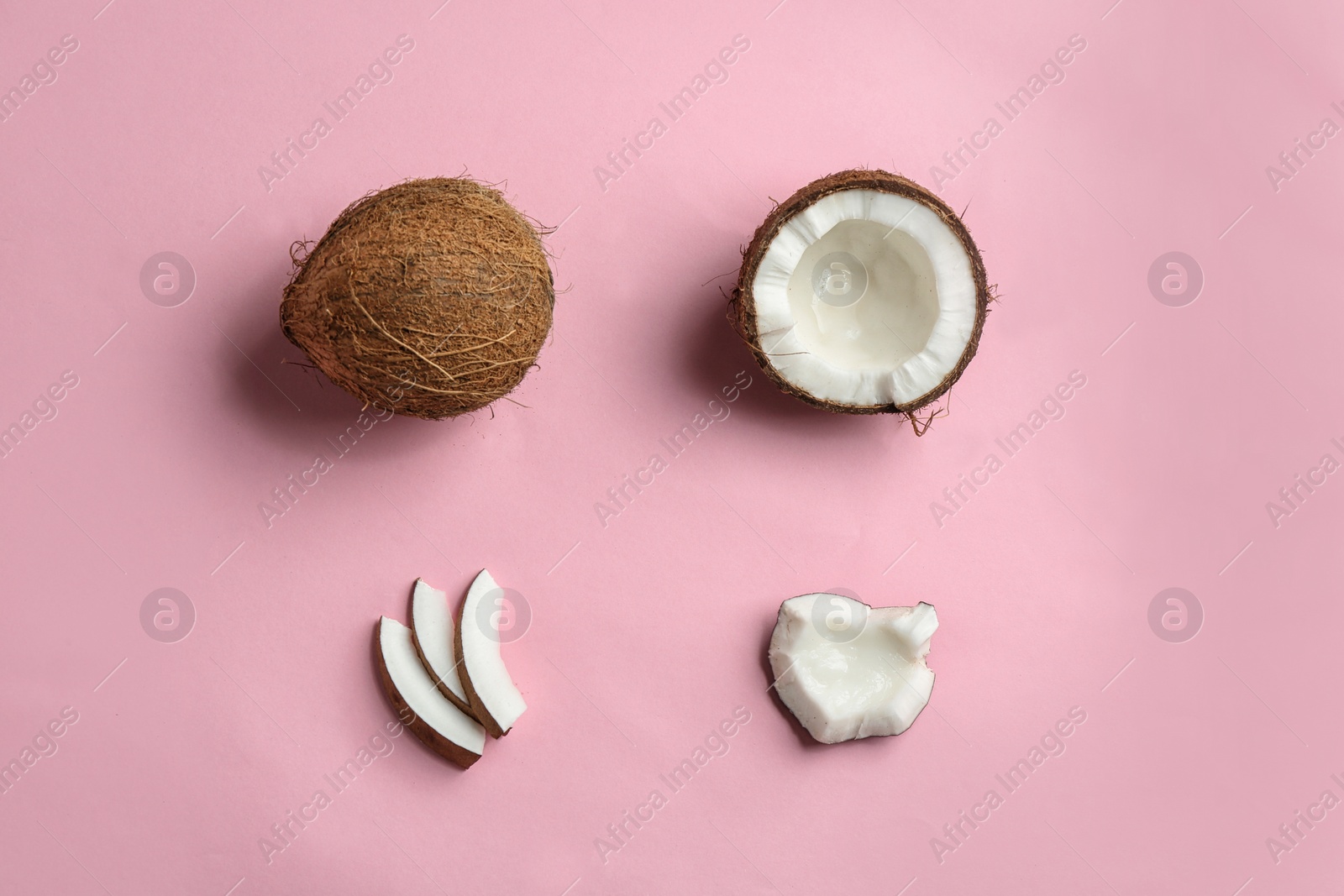 Photo of Flat lay composition with coconuts on color background