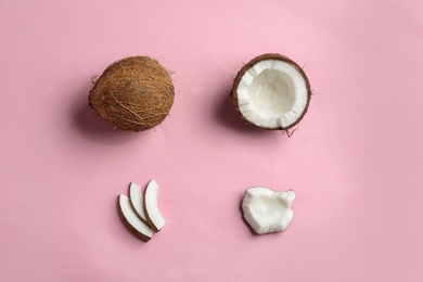 Flat lay composition with coconuts on color background