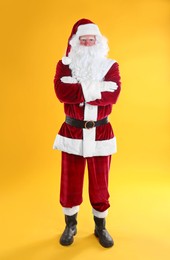 Full length portrait of Santa Claus on yellow background