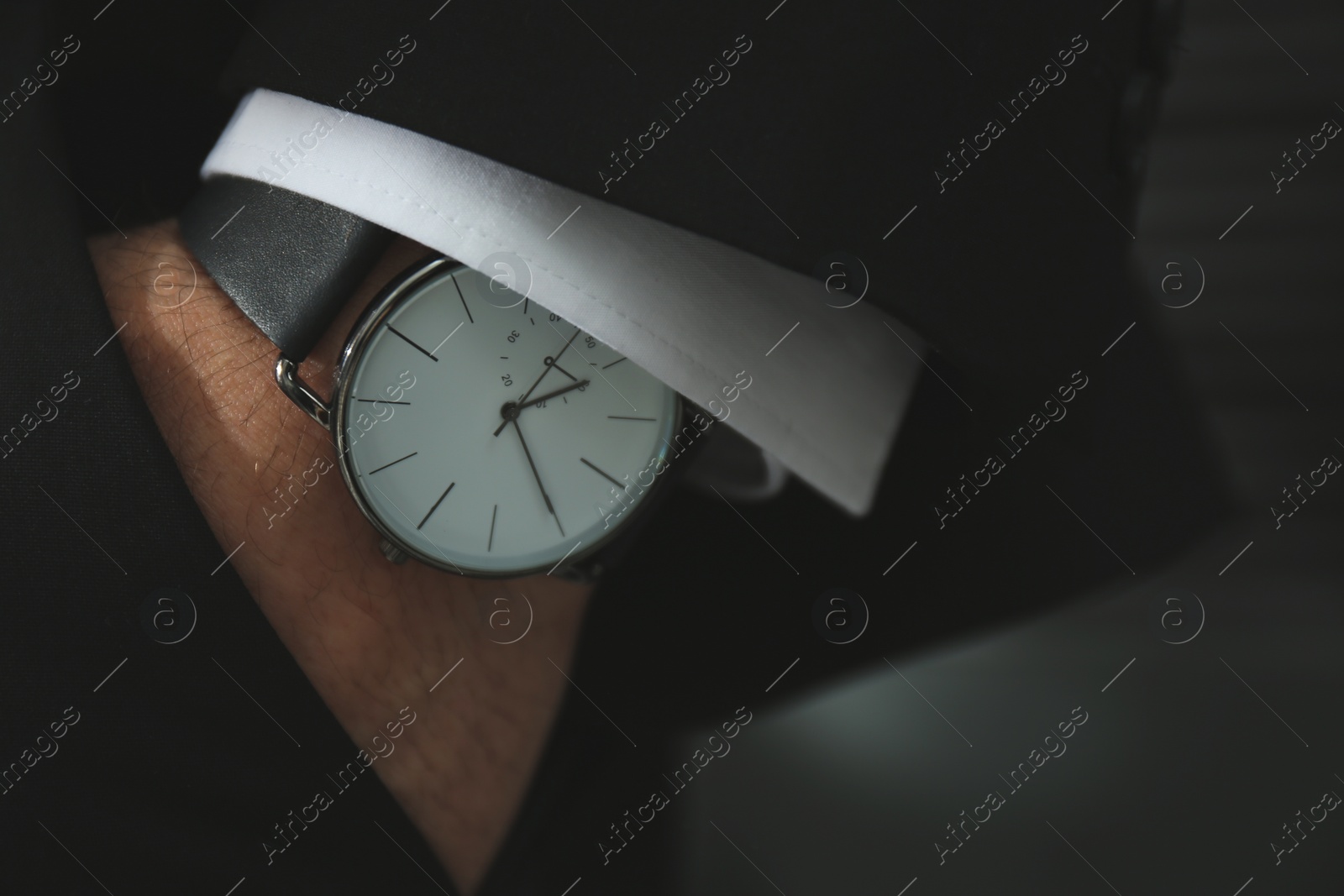 Photo of Businessman in suit with luxury wrist watch, closeup