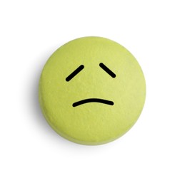 Yellow pill with sad face on white background