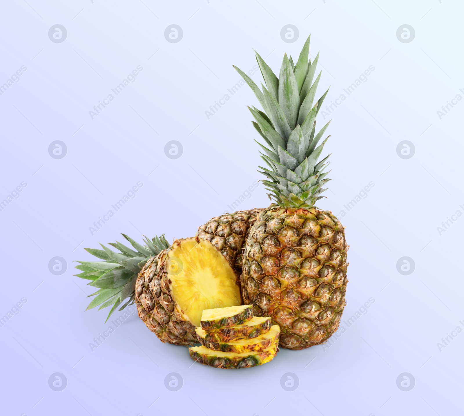 Image of Cut and whole pineapples on light blue background