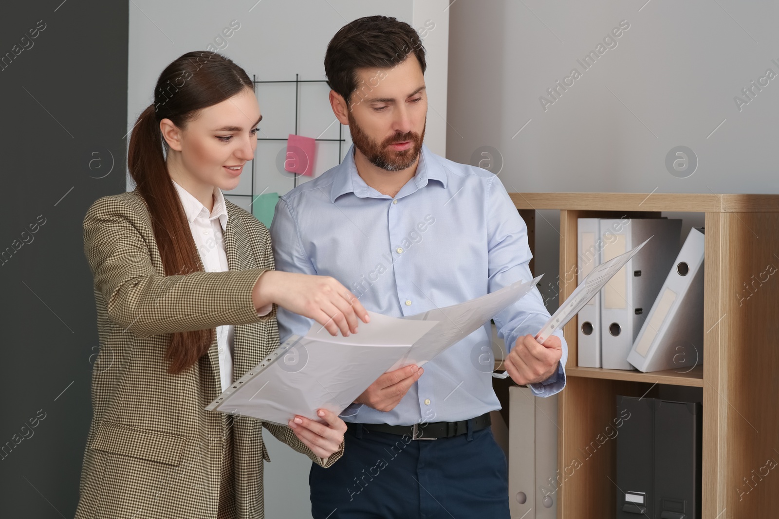 Photo of Businesspeople working together with documents in office