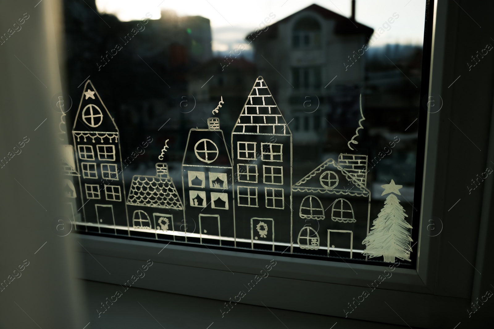 Photo of Beautiful drawing made with artificial snow on window. Christmas decor