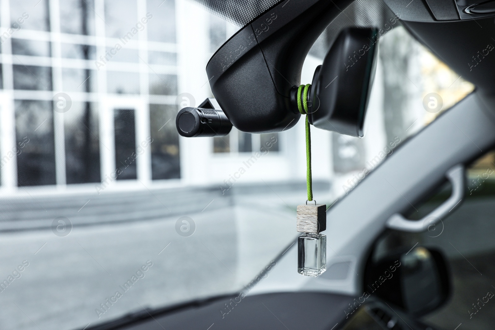 Photo of Air freshener hanging on rear view mirror in car