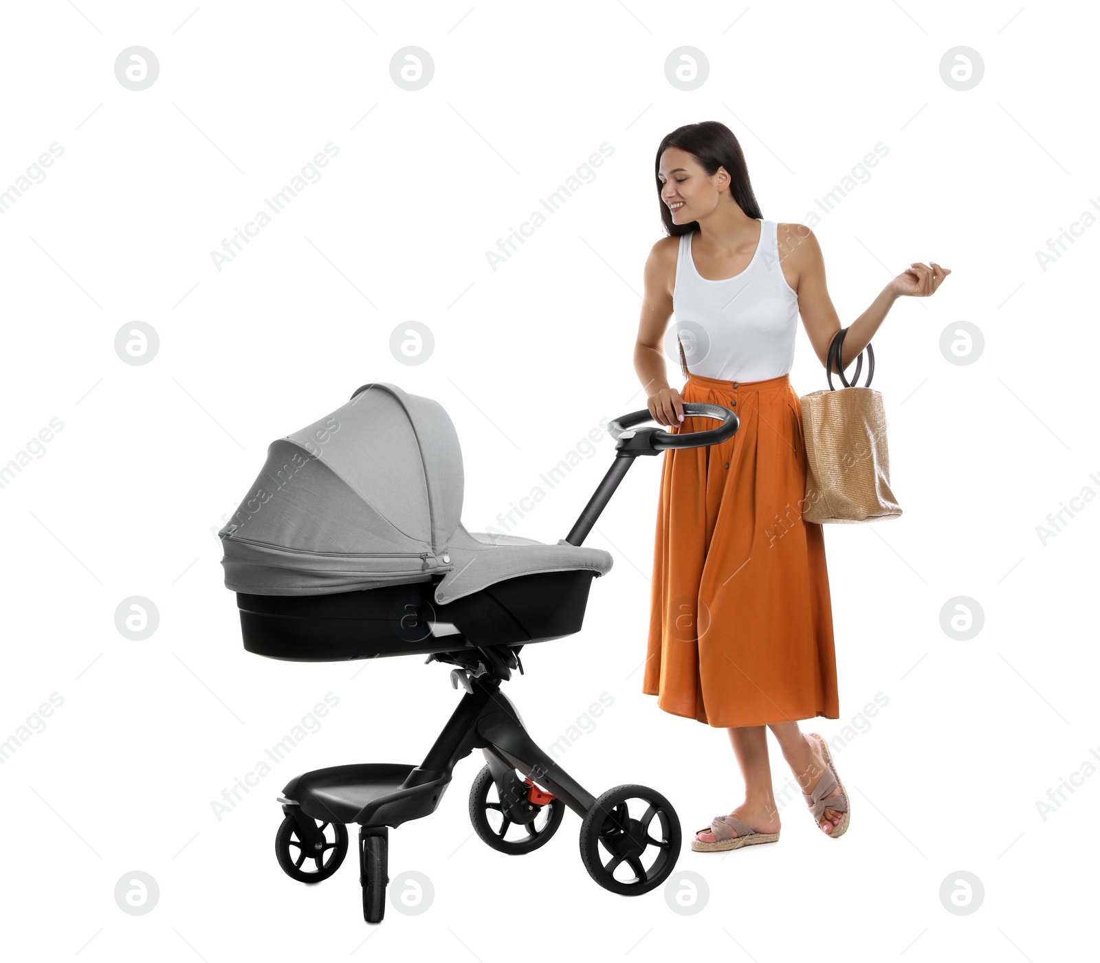 Photo of Happy young woman with baby stroller on white background