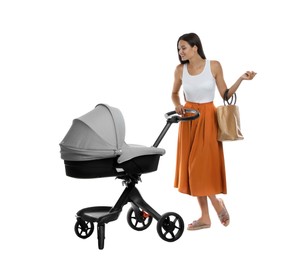Happy young woman with baby stroller on white background