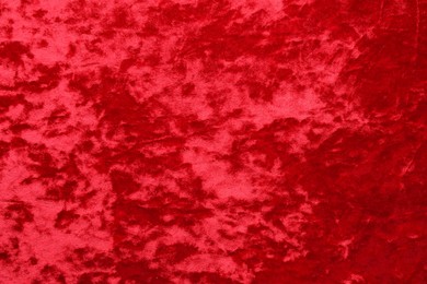 Photo of Texture of red velvet fabric as background, top view