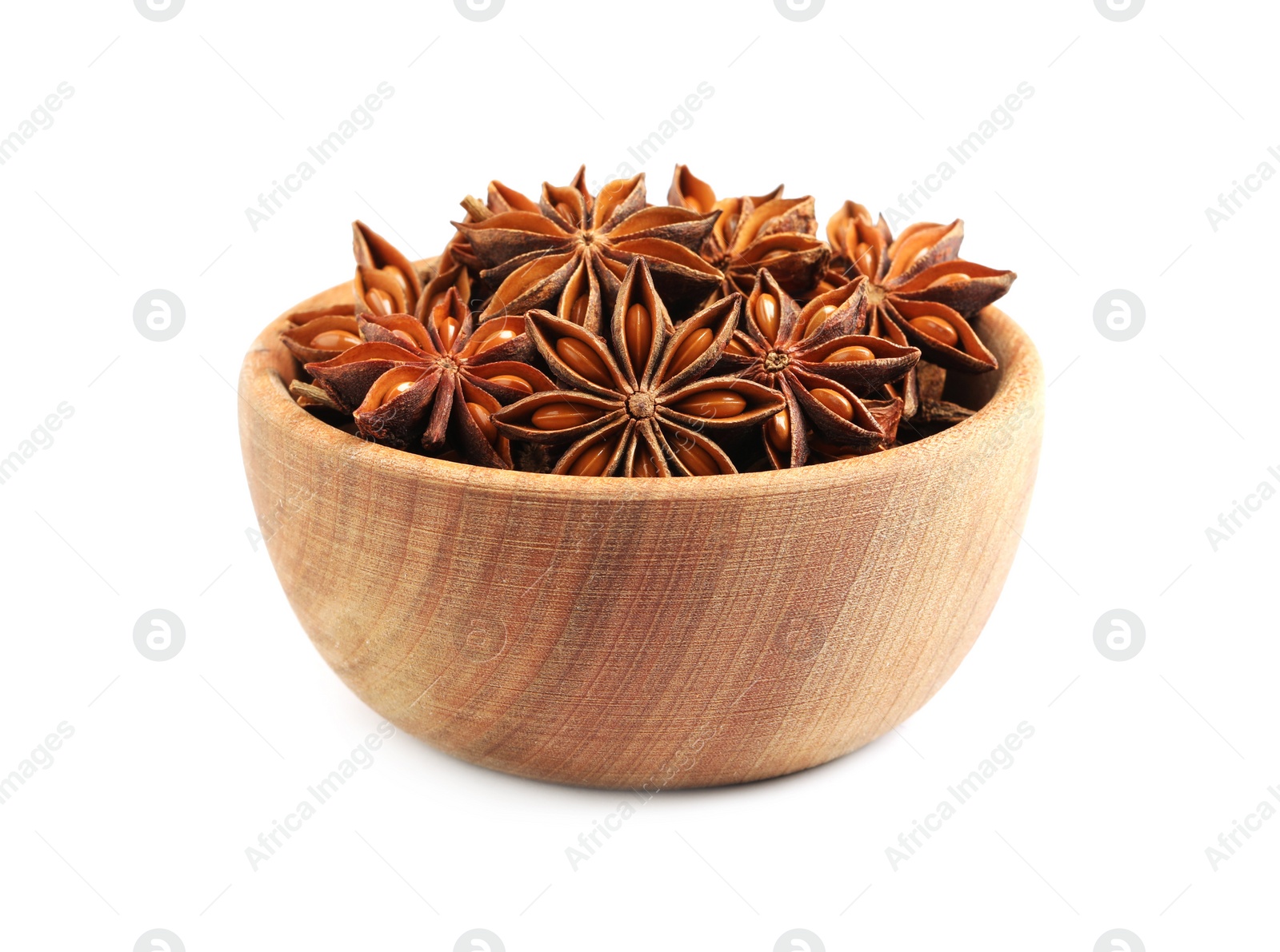 Photo of Wooden bowl with dry anise stars on white background