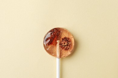 Photo of Sweet colorful lollipop with berries on beige background, top view