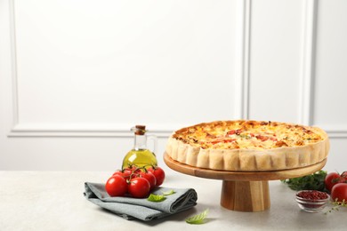 Photo of Tasty quiche and products served on light table, space for text