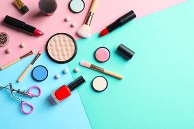 Photo of Flat lay composition with decorative cosmetics on color background