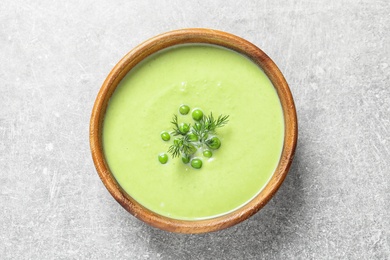 Fresh vegetable detox soup made of green peas in dish on table, top view