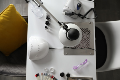 Professional equipment for manicure on table in beauty salon, top view