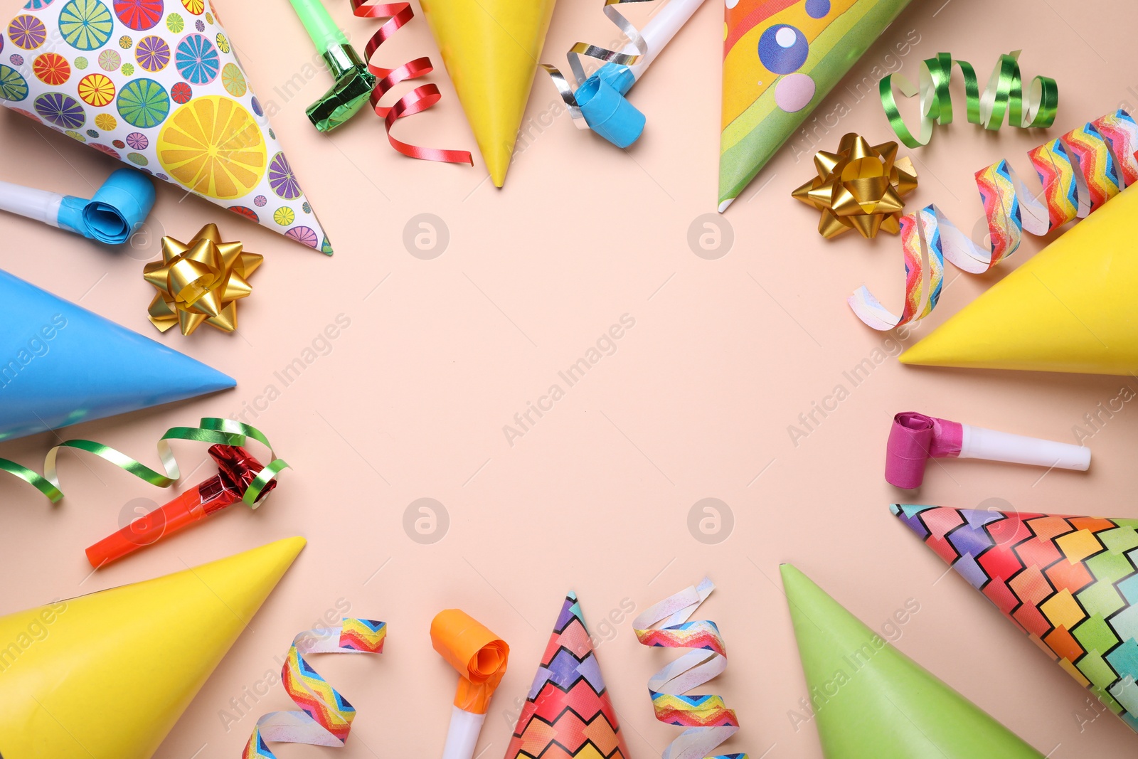 Photo of Flat lay composition with party items on pale pink background, space for text. Birthday celebration