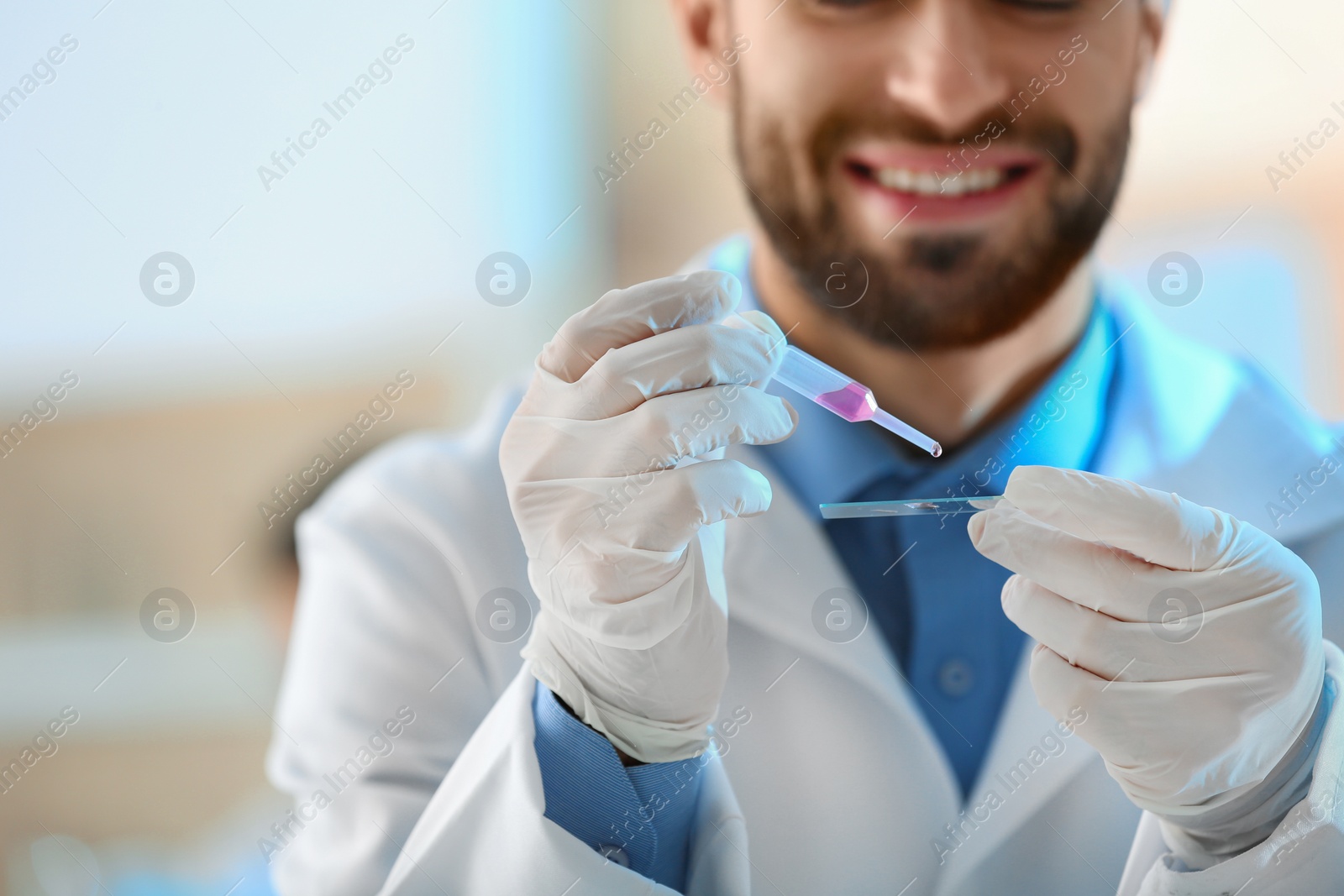 Photo of Young scientist working with fluid sample, closeup. Laboratory analysis