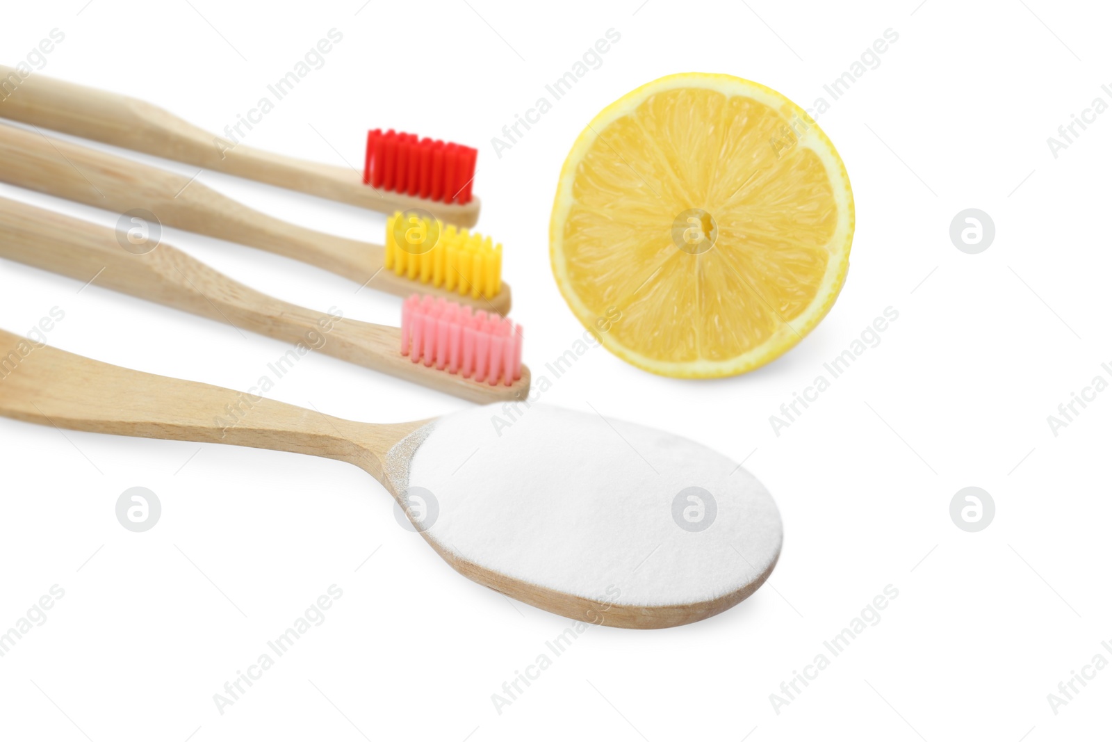 Photo of Bamboo toothbrushes, spoon with baking soda and fresh lemon on white background