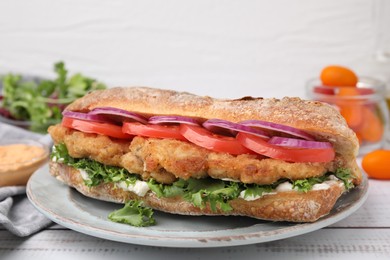 Photo of Delicious sandwich with schnitzel on white wooden table