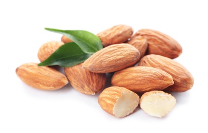 Photo of Organic almond nuts and leaves on white background. Healthy snack