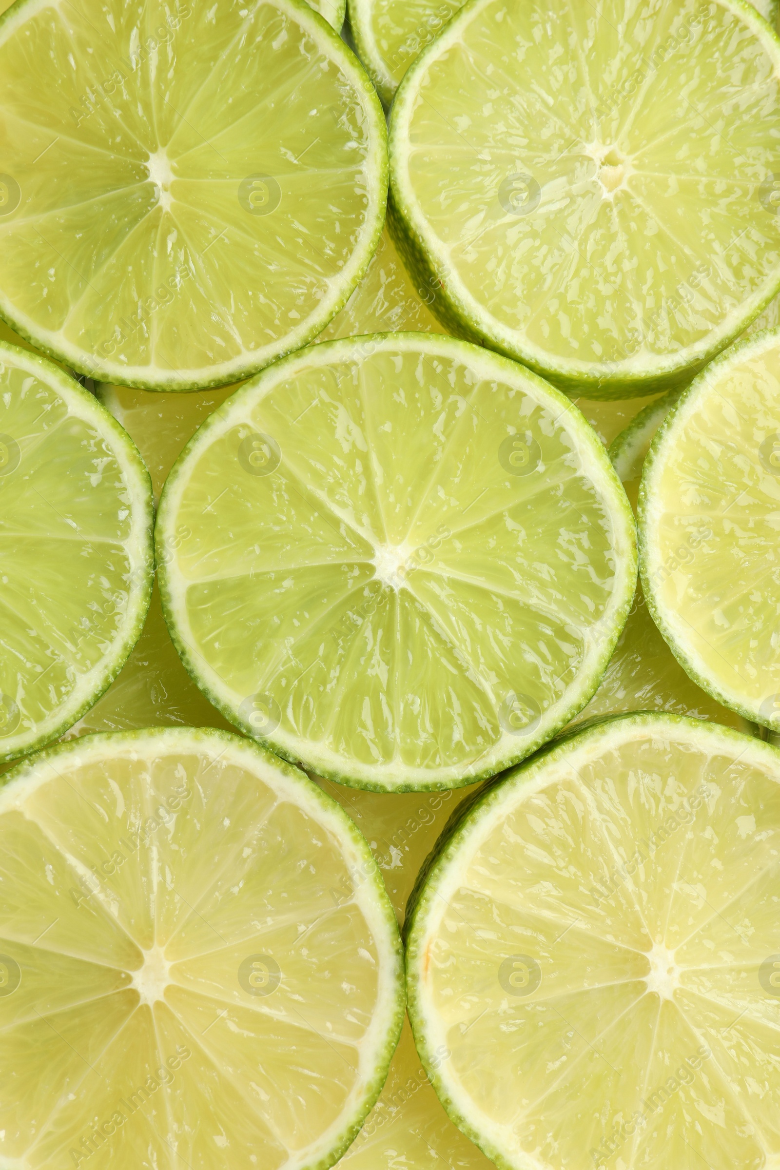 Photo of Fresh juicy lime slices as background, top view