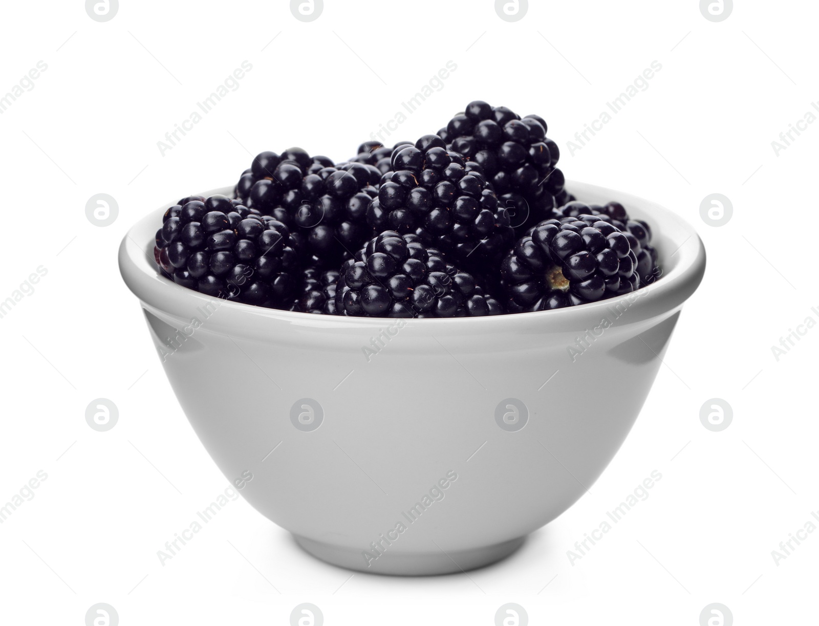 Photo of Ceramic bowl of tasty ripe blackberries on white background