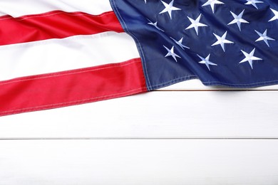 National flag of America and space for text on white wooden table, top view