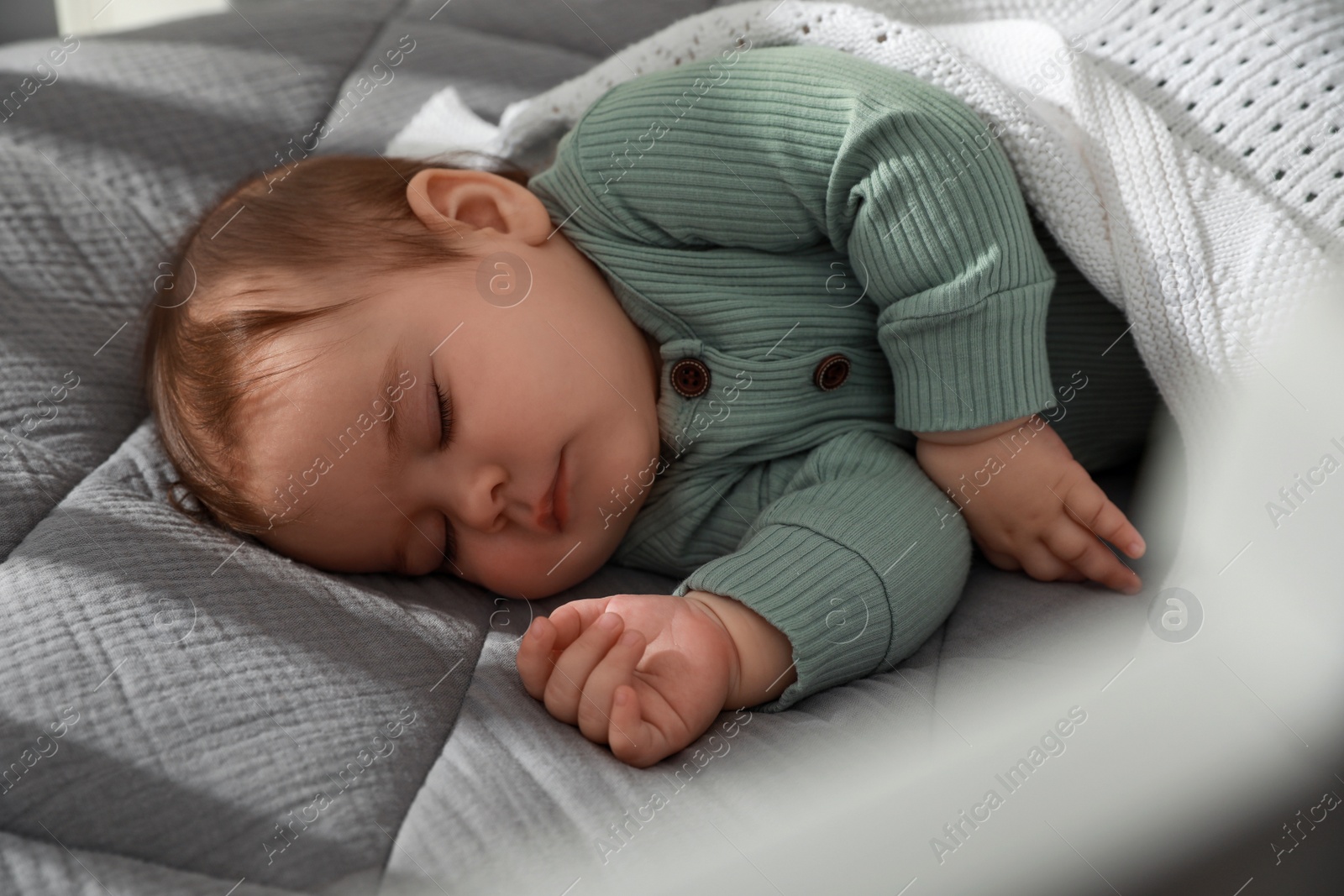 Photo of Cute little baby sleeping in bed, closeup