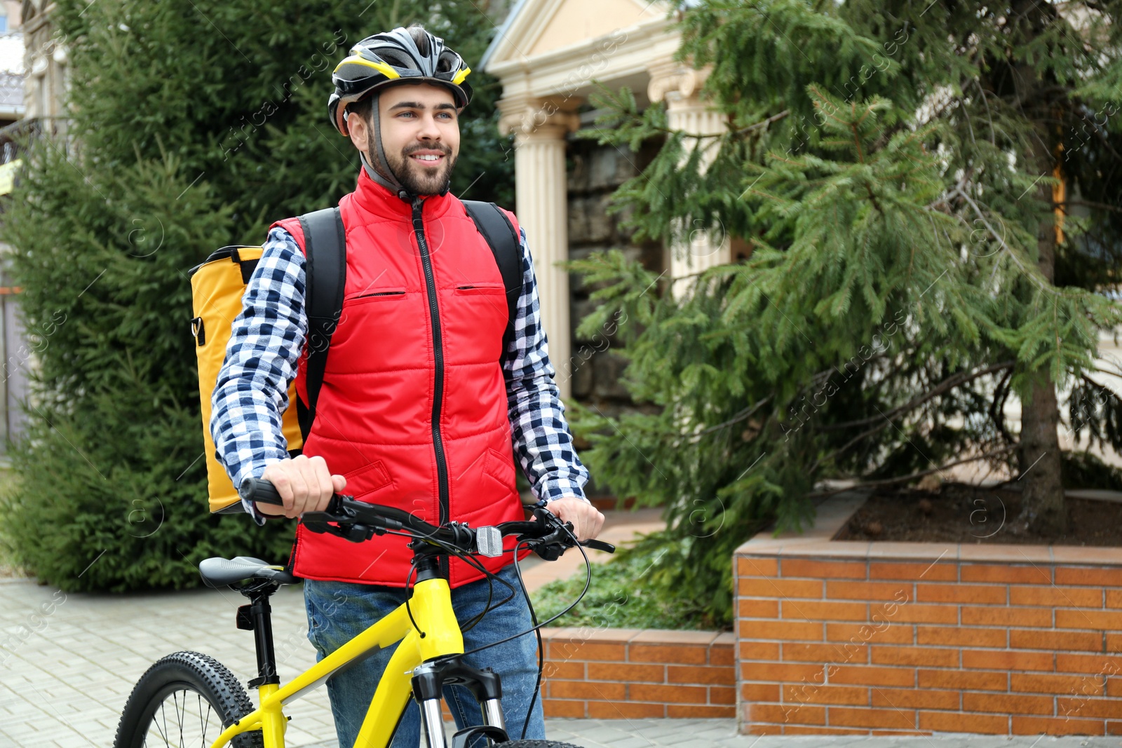 Photo of Courier with thermo bag and bicycle outdoors. Food delivery service