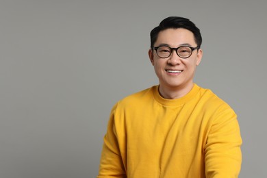 Photo of Portrait of happy man on grey background. Space for text