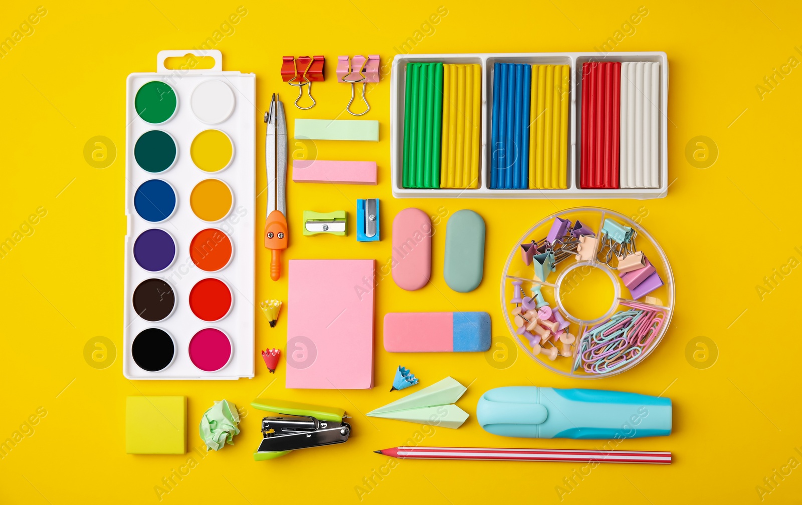 Photo of Many different school stationery on yellow background, flat lay. Back to school