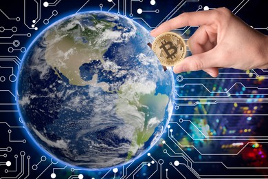 Image of World cryptocurrency. Man inserting bitcoin into globe against digital scheme and blurred cityscape