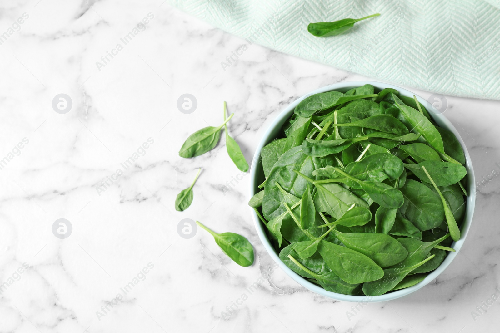 Photo of Fresh green healthy spinach on white marble table, flat lay. Space for text