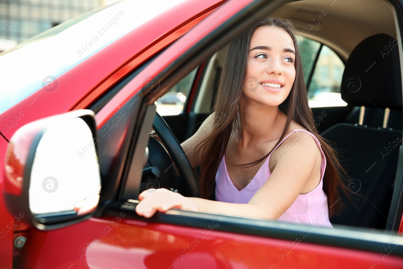 Photo of Young woman on driver's seat of car