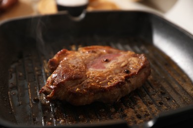 Photo of Frying pan with cooked tasty meat, closeup