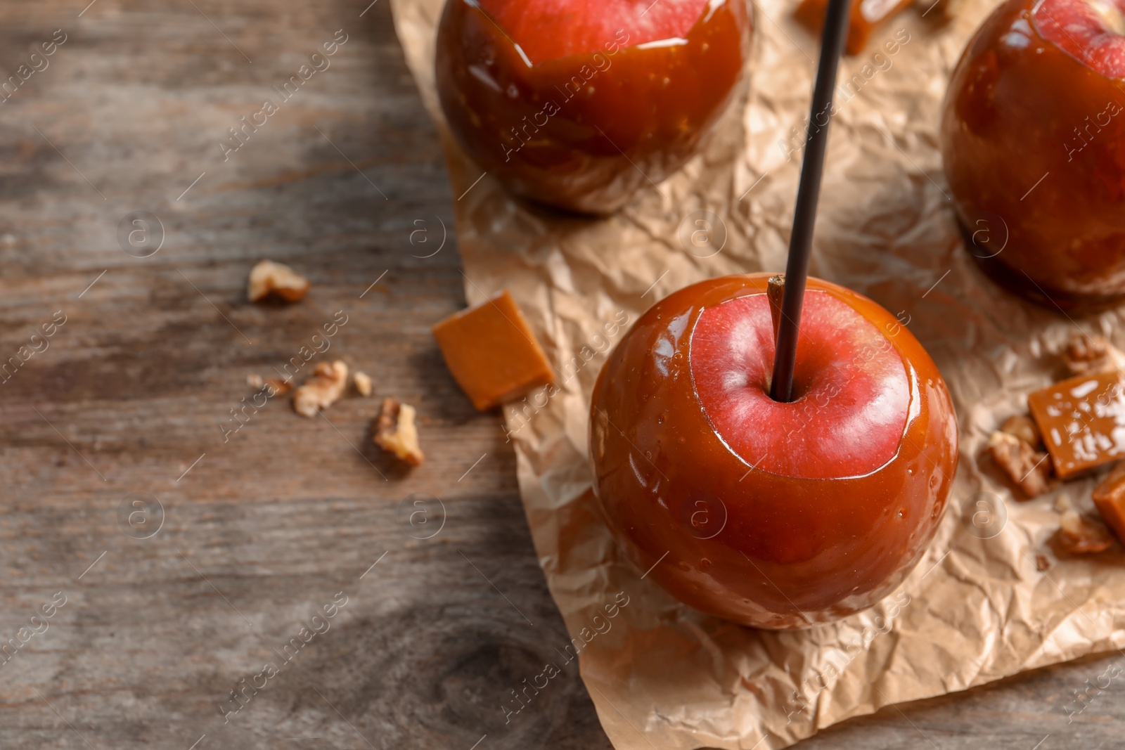 Photo of Delicious red caramel apples on table